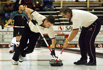 Dave Hamblin, current World Junior Champion yells directions down the ice while the other team looks on.